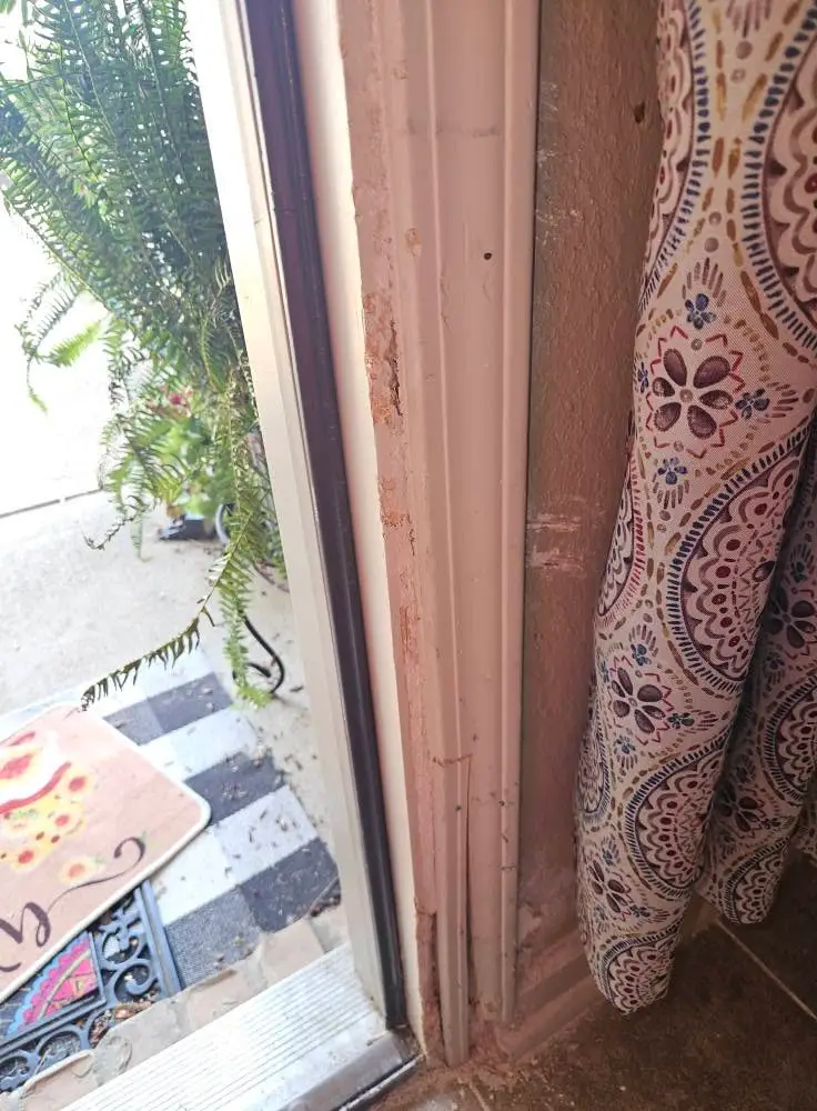 Before: door jamb split along its full height with the casing pulling away from the wall.