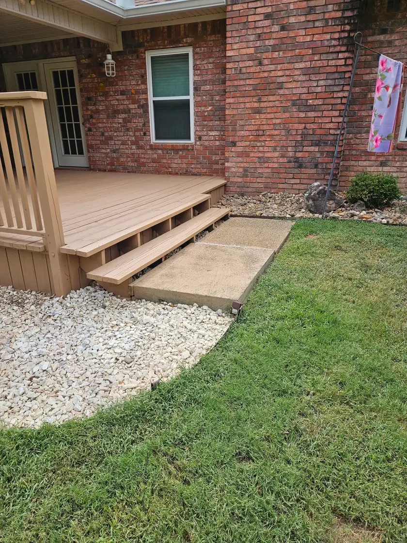 After: repainted deck steps down to the concrete pad, with the skirting boards finished to match.