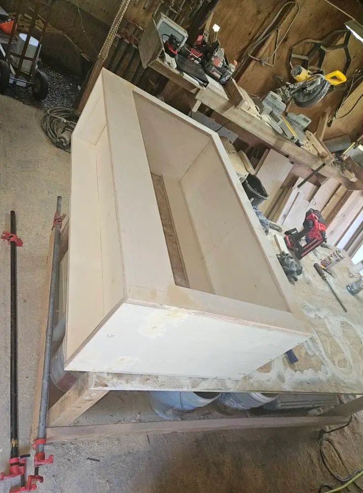 During: shop-built cabinet carcass clamped up on sawhorses, with the plywood joints glued and set.