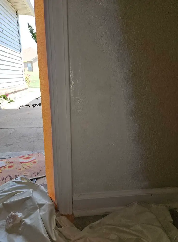 After: repaired wall corner filled, sanded and painted to match the surrounding texture.
