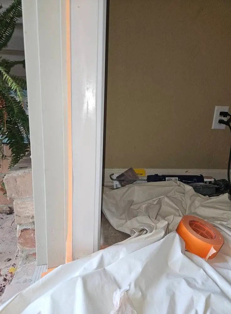 During: door casing masked in tape with the drop cloths down and the sander set aside.