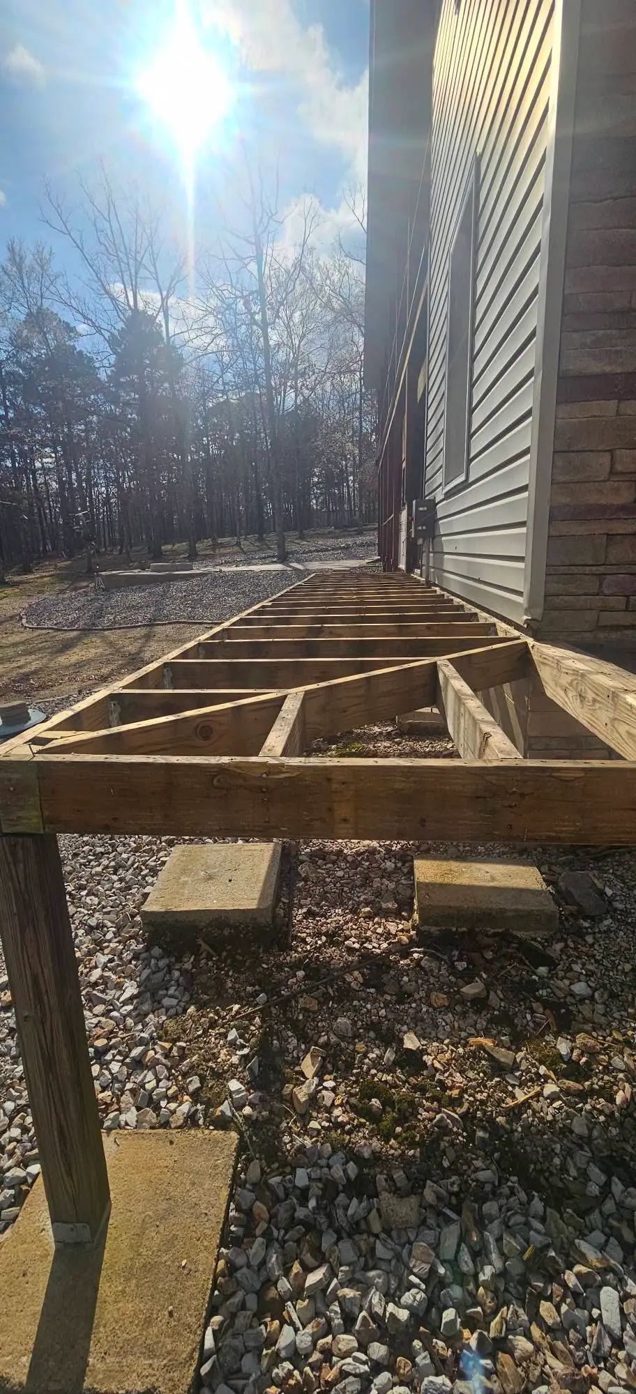 During: treated frame and blocking set on posts along the wall, squared and ready for composite boards.