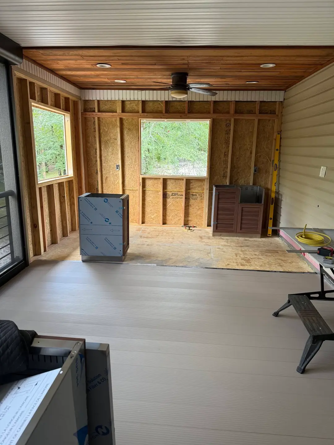 Before: porch framed out in studs and OSB sheathing with the composite floor down and the cedar ceiling started.